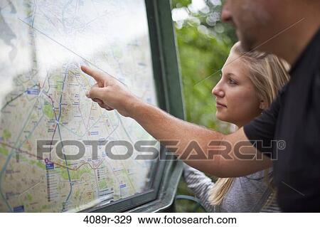 Stock Photo - France, Ile-De-France, Paris, Man observing metro map with teenage daughter. Fotosearch