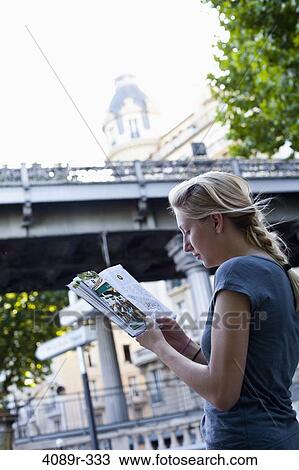 France, Ile-De-France, Paris, Teenage girl reading guidebook View Large Photo Image Stock Image - France, Ile-De-France, Paris, Teenage girl reading guidebook. Fotosearch
