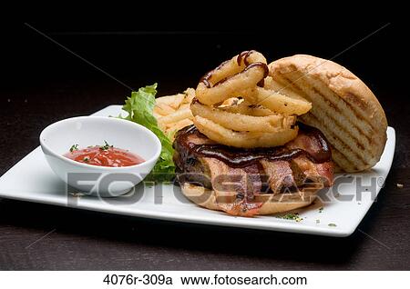 French fries and a hamburger with a bowl of ketchup View Large Photo Image Stock Image - French fries and a hamburger with a bowl of ketchup. Fotosearch