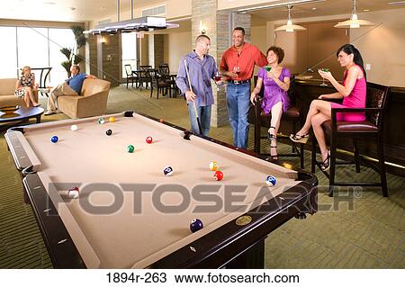 Friends having drinks in the bar of a tourist resort View Large Photo Image Stock Image - Friends having drinks in the bar of a tourist resort. Fotosearch