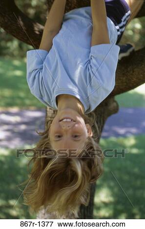 Girl hanging from a tree View Large Photo Image Stock Photo - Girl hanging from a tree. Fotosearch