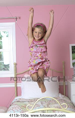 Girl jumping on the bed View Large Photo Image Stock Image - Girl jumping on the bed. Fotosearch