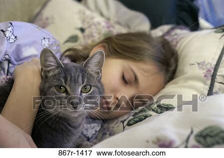 Stock Photo - Girl sleeping with her cat. Fotosearch