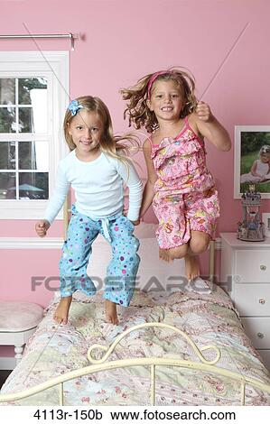 Girls jumping on the bed View Large Photo Image Stock Image - Girls jumping on the bed. Fotosearch