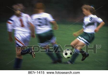 Girls playing soccer on a field View Large Photo Image Stock Photography - Girls playing soccer on a field. Fotosearch