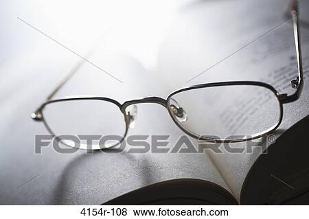 Glasses on open book View Large Photo Image Stock Photo - Glasses on open book. Fotosearch