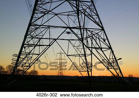 Stock Image - Great Britain, British Isles, electricity pylon of National Grid at sunset. Fotosearch