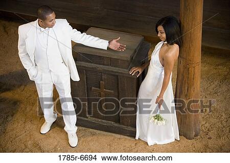 Picture - Groom beckoning bride. Fotosearch