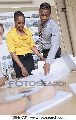 Stock Image - Group collaborating on project at office. Fotosearch