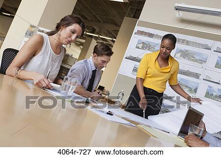 Stock Photo - Group collaborating on project at office. Fotosearch