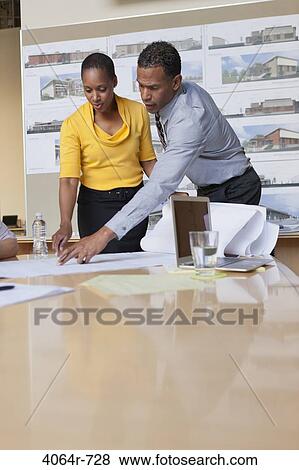 Stock Photo - Group collaborating on project at office. Fotosearch