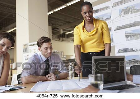 Stock Photography - Group collaborating on project at office. Fotosearch
