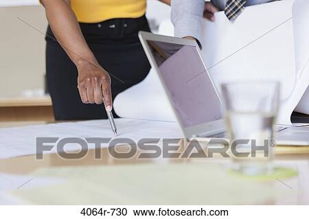 Stock Image - Group collaborating on project at office, close-up. Fotosearch