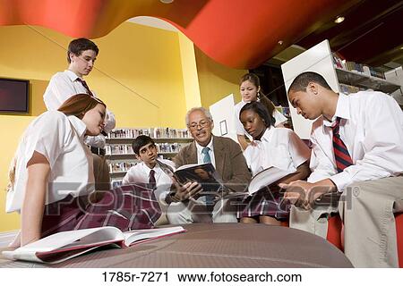 Group of high school students hanging out in library with teacher View Large Photo Image Stock Image - Group of high school students hanging out in library with teacher. Fotosearch