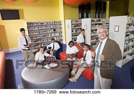 Group of high school students hanging out in library with teacher View Large Photo Image Stock Photo - Group of high school students hanging out in library with teacher. Fotosearch
