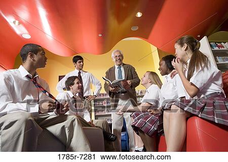 Group of high school students in library with teacher View Large Photo Image Stock Image - Group of high school students in library with teacher. Fotosearch
