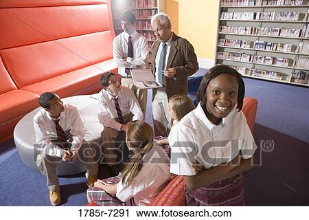 Group of high school students in library with teacher View Large Photo Image Stock Image - Group of high school students in library with teacher. Fotosearch