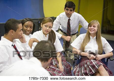 Group of high school students in uniforms conversing View Large Photo Image Stock Image - Group of high school students in uniforms conversing. Fotosearch