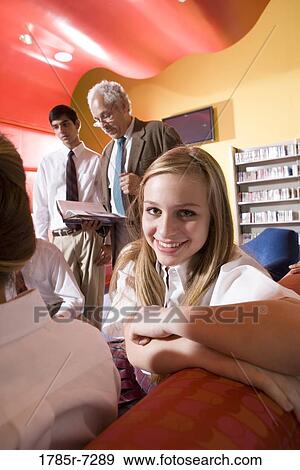 Group of high school students in library with teacher View Large Photo Image Stock Photo - Group of high school students in library with teacher. Fotosearch