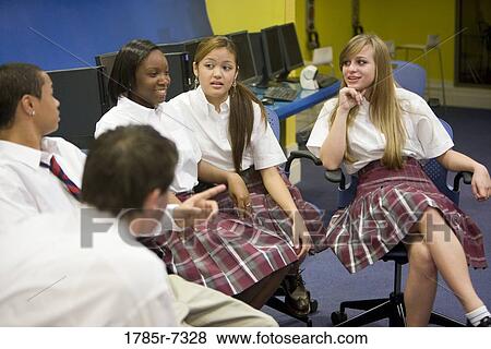 Stock Photo - Group of high school students in uniforms conversing. Fotosearch