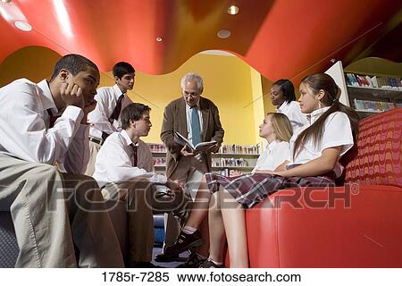 Group of high school students in library with teacher View Large Photo Image Stock Photography - Group of high school students in library with teacher. Fotosearch