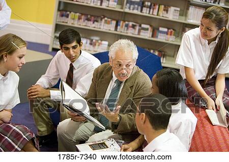 Group of high school students reading in library with teacher View Large Photo Image Stock Image - Group of high school students reading in library with teacher. Fotosearch