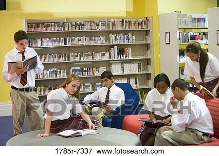 Stock Photo - Group of high school students reading in library. Fotosearch