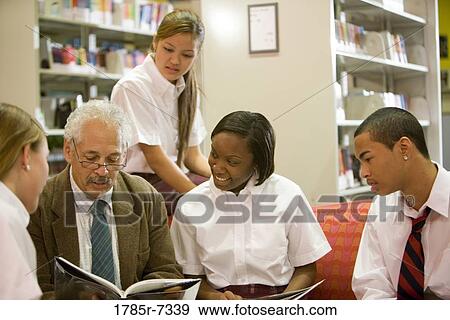 Group of high school students reading in library with teacher View Large Photo Image Stock Photo - Group of high school students reading in library with teacher. Fotosearch