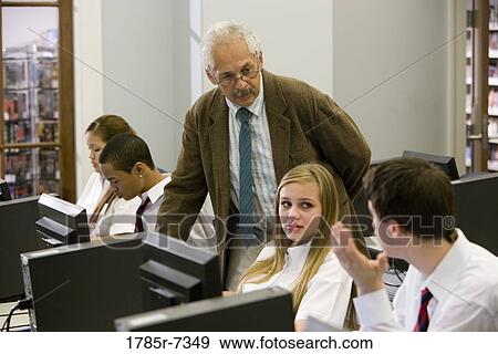 Group of high school students with their teacher in a computer lab View Large Photo Image Stock Photo - Group of high school students with their teacher in a computer lab. Fotosearch