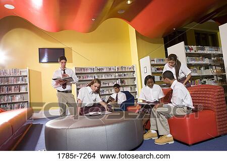 Group of teenage students hanging out in lounge area of library View Large Photo Image Picture - Group of teenage students hanging out in lounge area of library. Fotosearch