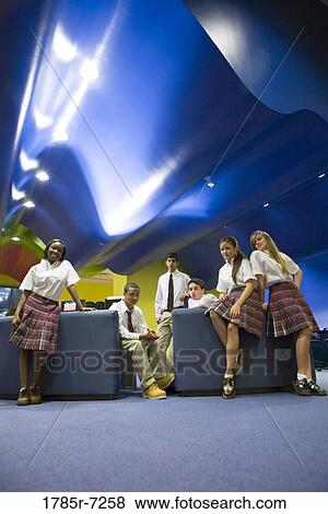 Group of teenage students hanging out in lounge area of library View Large Photo Image Stock Photo - Group of teenage students hanging out in lounge area of library. Fotosearch