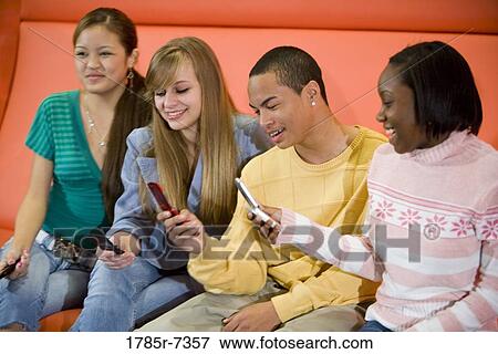 Group of teenagers with their cellphones View Large Photo Image Stock Photo - Group of teenagers with their cellphones. Fotosearch