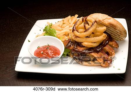 Stock Image - Hamburger and French fries with a bowl of ketchup. Fotosearch