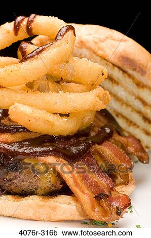 Stock Image - Hamburger with onion rings. Fotosearch