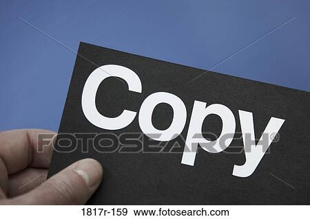Stock Photo - Hand holding card highlighting the word copy. Fotosearch