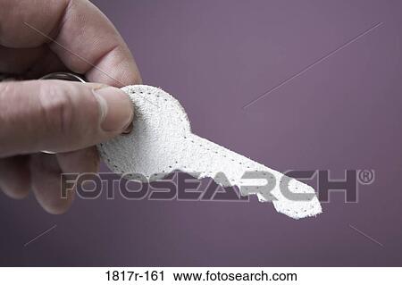 Hand holding key shaped keyring View Large Photo Image Stock Image - Hand holding key shaped keyring. Fotosearch