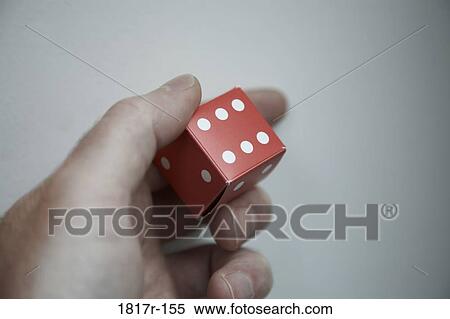 Stock Photography - Hand holding red cardboard dice. Fotosearch