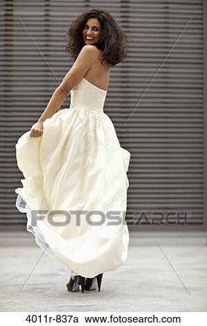Stock Image - Happy bride dancing. Fotosearch