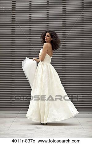 Stock Image - Happy bride dancing. Fotosearch