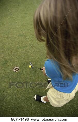 High angle view of a girl playing golf View Large Photo Image Stock Photograph - High angle view of a girl playing golf. Fotosearch