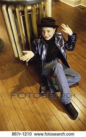 High angle view of a mid adult woman sitting on the floor View Large Photo Image Stock Image - High angle view of a mid adult woman sitting on the floor. Fotosearch
