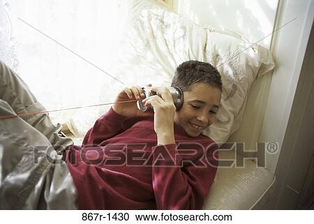 High angle view of a teenage boy playing with string and a can View Large Photo Image Stock Image - High angle view of a teenage boy playing with string and a can. Fotosearch