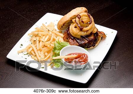 High angle view of French fries and a burger with a bowl of ketchup View Large Photo Image Stock Image - High angle view of French fries and a burger with a bowl of ketchup. Fotosearch