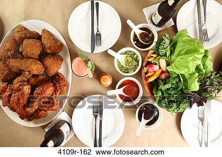 High angle view of friend chicken served on a dining table View Large Photo Image Stock Image - High angle view of friend chicken served on a dining table. Fotosearch
