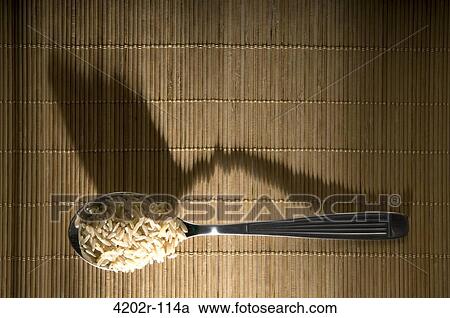 High angle view of uncooked rice in a spoon View Large Photo Image Stock Image - High angle view of uncooked rice in a spoon. Fotosearch