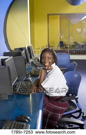 High school student wearing a uniform sitting alone in a computer lab View Large Photo Image Stock Image - High school student wearing a uniform sitting alone in a computer lab. Fotosearch