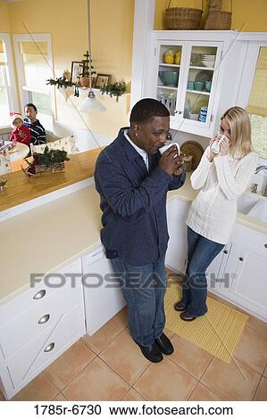 Interracial couple in then kitchen with children in background View Large Photo Image Stock Image - Interracial couple in then kitchen with children in background. Fotosearch