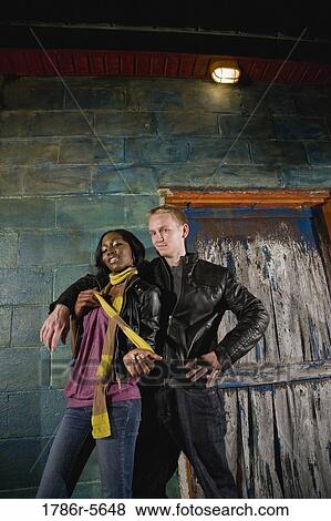 Interracial couple standing by grungy doorway View Large Photo Image Stock Photo - Interracial couple standing by grungy doorway. Fotosearch