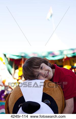 Little boy posing with stuffed animal prize at the fair View Large Photo Image Picture - Little boy posing with stuffed animal prize at the fair. Fotosearch