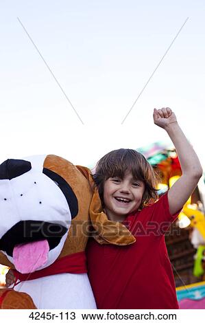 Little boy posing with stuffed animal prize at the fair View Large Photo Image Stock Image - Little boy posing with stuffed animal prize at the fair. Fotosearch
